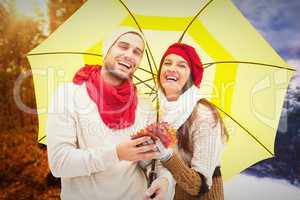 Composite image of autumn couple holding umbrella