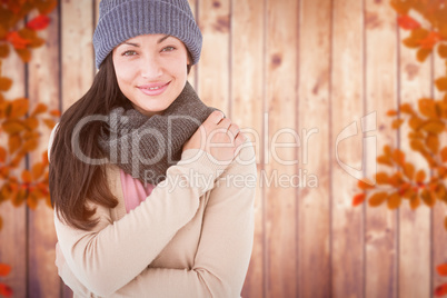 Composite image of attractive brunette looking at camera wearing