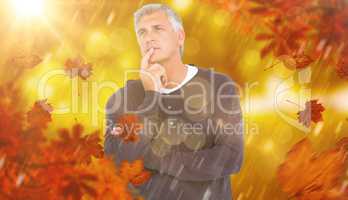 Composite image of casual man thinking with hand on chin