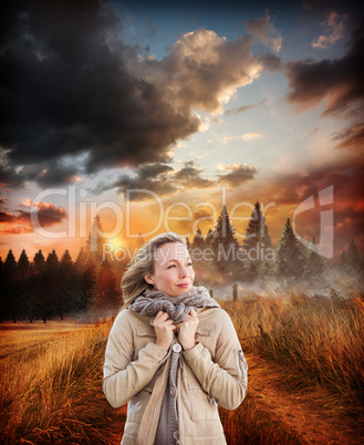 Composite image of pretty blonde in warm clothes