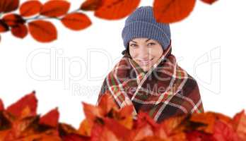 Composite image of smiling brunette with checked blanket
