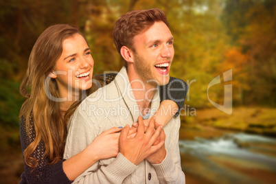 Composite image of cheerful young couple embracing