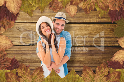 Composite image of happy hipster couple smiling at camera