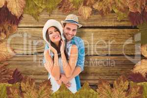 Composite image of happy hipster couple smiling at camera