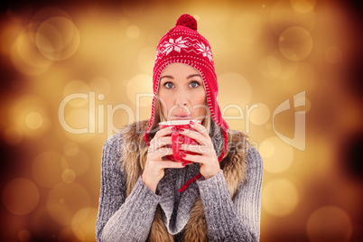 Composite image of blonde in winter clothes smiling at camera