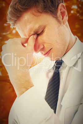 Composite image of businessman with a headache