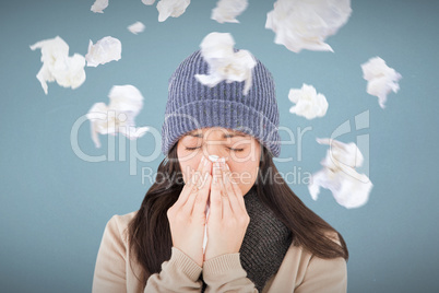 Composite image of sick brunette blowing her nose
