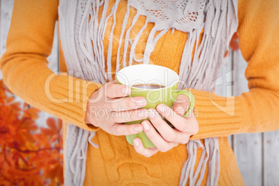 Composite image of close up of woman drinking from a cup