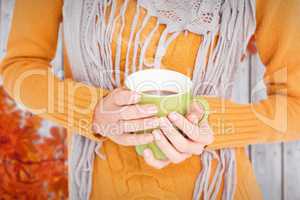 Composite image of close up of woman drinking from a cup