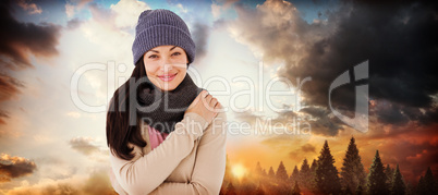 Composite image of attractive brunette looking at camera wearing