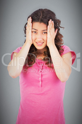 Composite image of cute brunette having headache