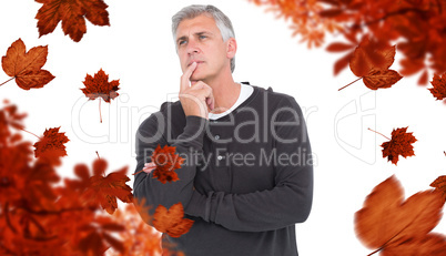 Composite image of casual man thinking with hand on chin