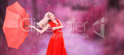 Composite image of elegant blonde holding umbrella