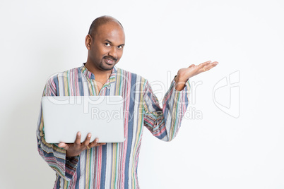 Indian man using computer and showing something