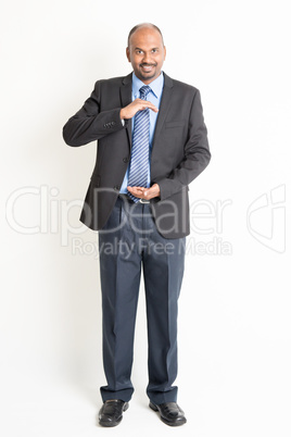 Full length mature Indian businessman holding something