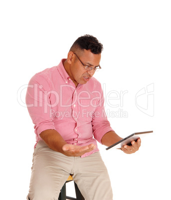 Man angry at his tablet computer.