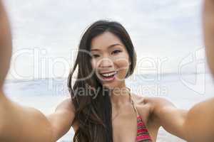 Asian Woman Girl at Beach Taking Selfie Photograph