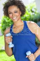 African American Woman Exercising With Weights Outside