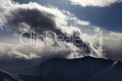 Evening dark mountain and sunlight clouds