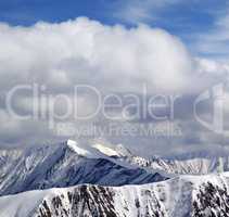 Winter snowy mountains and sky with clouds at nice day