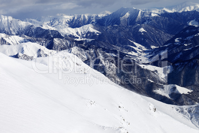 Off-piste slope and snowy mountains