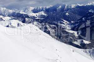 Off-piste slope and snowy mountains