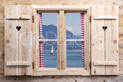 Wooden window with a lake as reflections