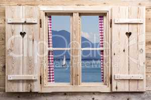 Wooden window with a lake as reflections