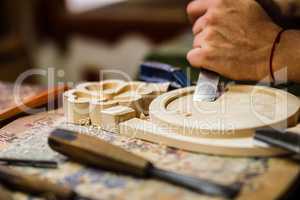Carpenter hand carving wood with care