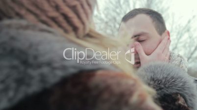 Woman touching boyfriend cheeks