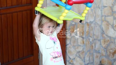Adorable little girl having fun with a swing