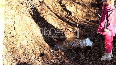 Little girl with a Brown Labrador retriever by a little pond