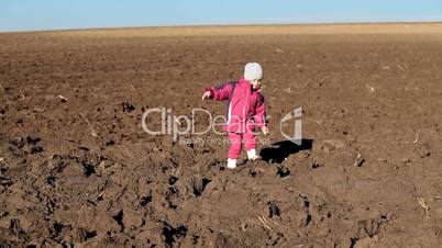 Little girl falling over on a fields