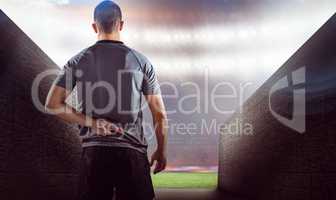 Composite image of rear view of rugby player with fingers crosse