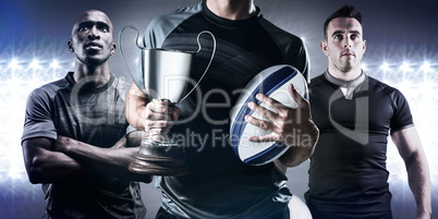 Composite image of midsection of successful rugby player holding Composite image of midsection of successful rugby player holding