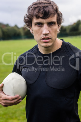 Rugby player scowling at camera