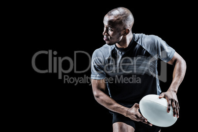 Composite image of athlete running with rugby ball