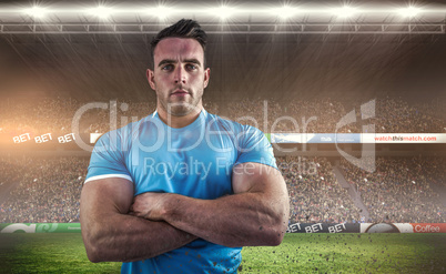 Composite image of rugby player looking at camera