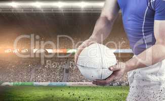 Composite image of rugby player about to throw the rugby ball