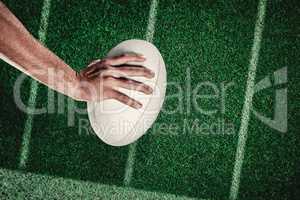 Composite image of cropped image of sports player holding ball