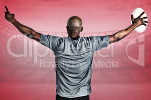 Composite image of rear view of sportsman with arms raised holdi