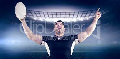 Composite image of rugby player cheering with the ball