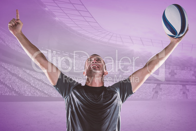 Composite image of successful rugby player holding ball with arm