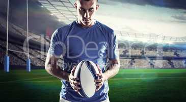 Composite image of rugby player holding ball