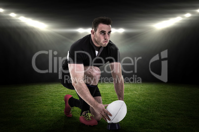 Composite image of rugby player getting ready to kick ball