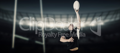 Composite image of rugby player catching a rugby ball