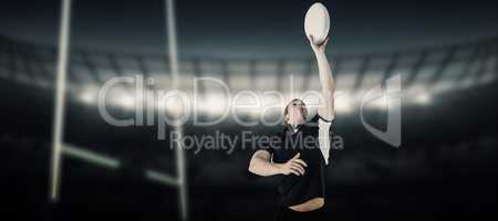 Composite image of rugby player catching a rugby ball