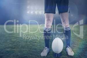 Composite image of rugby player ready to make a drop kick