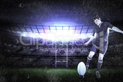 Composite image of rugby player doing a drop kick