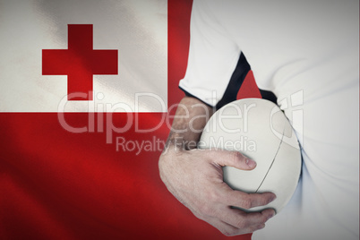 Composite image of midsection of rugby player holding ball